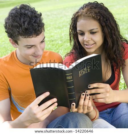 Two teens hang out in a park and read a bible