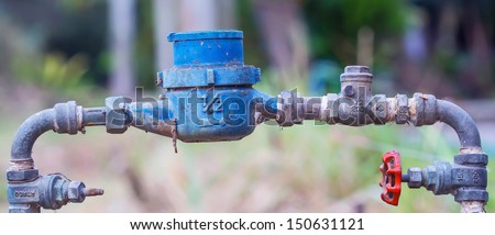 Rusting old water valve with water meter