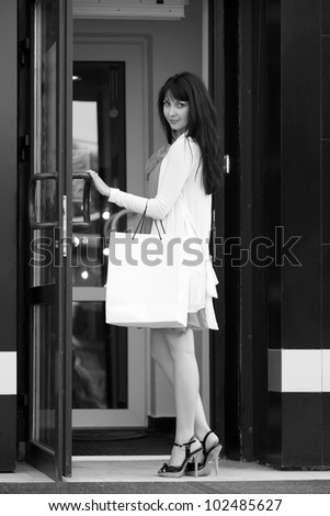 Young female shopper in a mall doorway