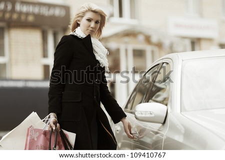 Young female shopper with a car