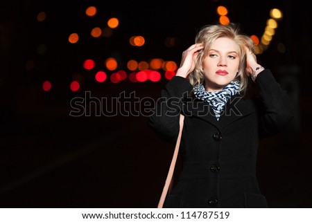 Young woman on the night city street