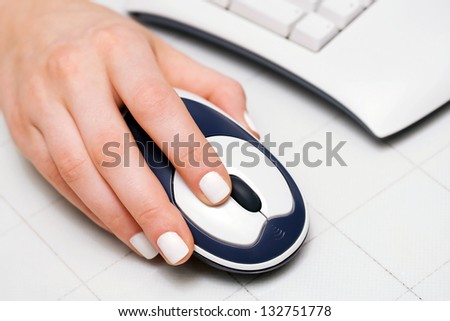 Female hand holding computer mouse