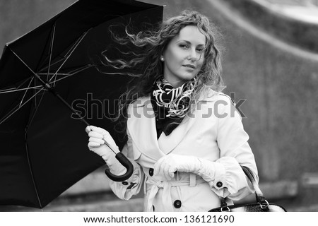 Woman with umbrella in the wind