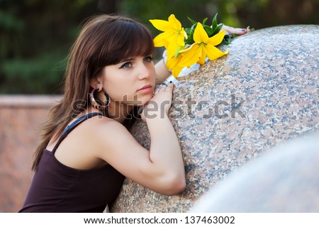 Sad young woman with a flowers