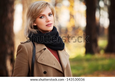 Happy blond woman in autumn forest