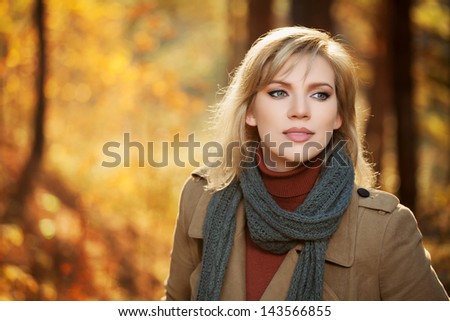 Blond woman in autumn forest