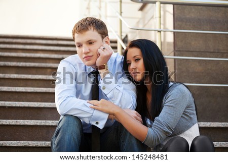 Young couple in depression sitting on the steps