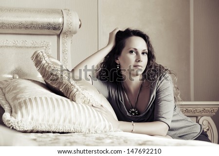 Beautiful woman relaxing in a bedroom