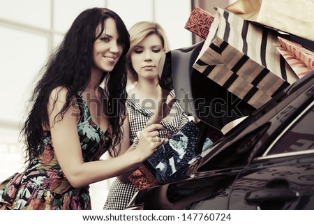 Two female shoppers at the car