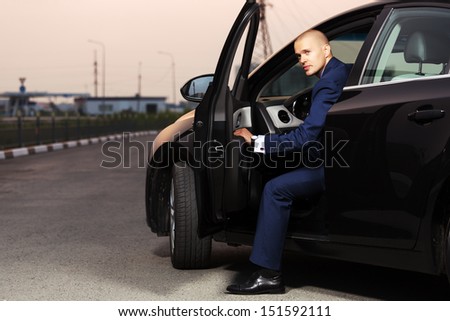 Young businessman sitting in the car