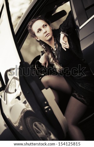 Beautiful woman sitting in a sports car