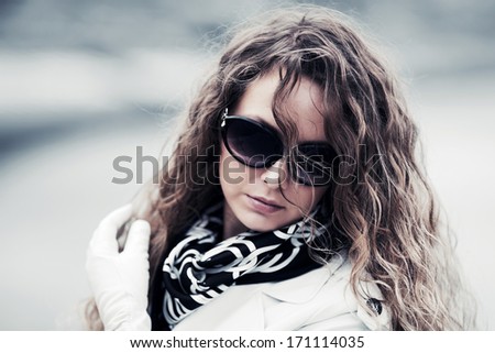Sad young woman with long hairs looking down