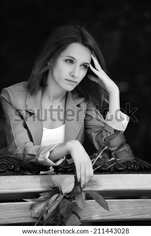 Sad young fashion woman with a roses