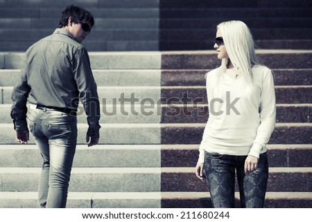 Young fashion man and woman on the steps