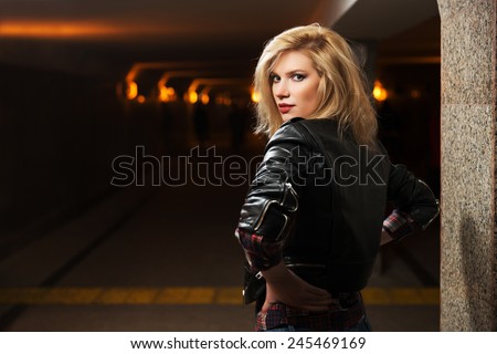 Young fashion blond woman in leather jacket