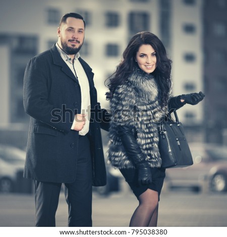 Happy young fashion couple walking in city street Stylish male and female models outdoor