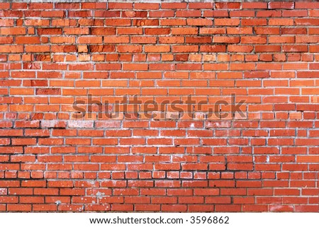 Grunge brick wall laid with a red brick.
