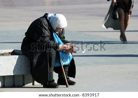 The poor old woman begging an alms.