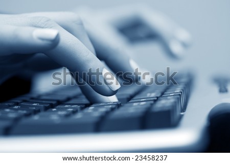 Female hands typing on keyboard.