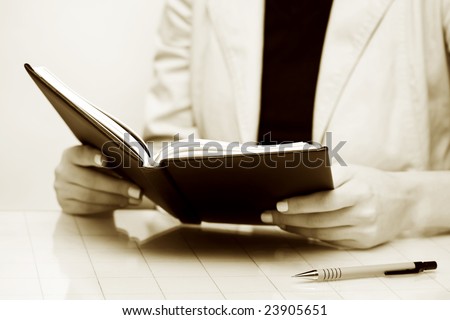 Businesswoman reading the accounting ledger.