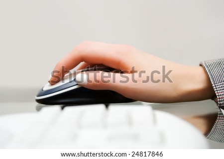Female hand holding computer mouse.