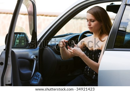 Young woman having make-up in the car.