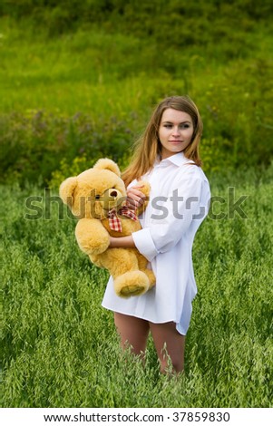 Happy young woman with teddy bear.