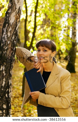 Young businesswoman with a notebook on nature.