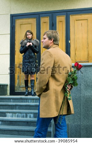 Young man with a roses waiting his girlfriend.