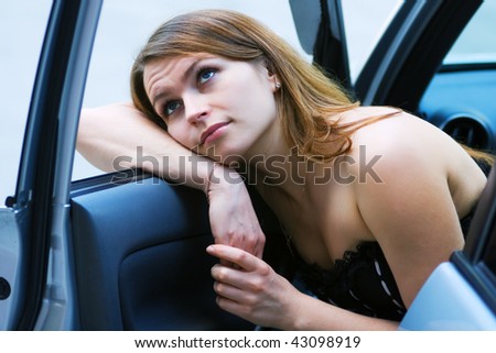 Tired young woman resting in the car.