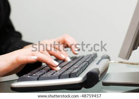 Female hands working on computer.