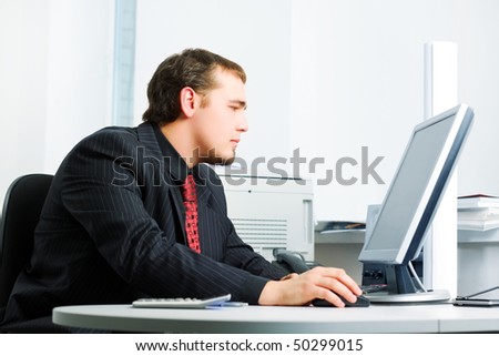 Young businessman working on computer.