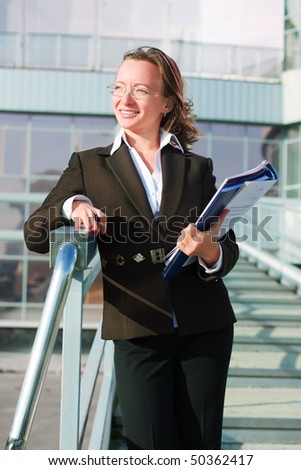 Businesswoman on the stairway of airport terminal.