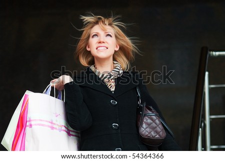 Happy young woman with shopping bags.