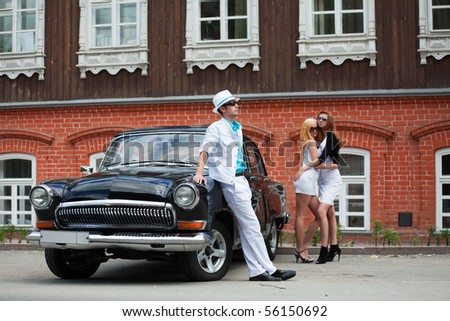 Young people with a retro car.