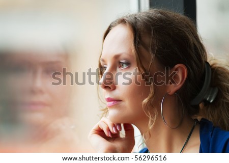 Beautiful woman looking through a window.