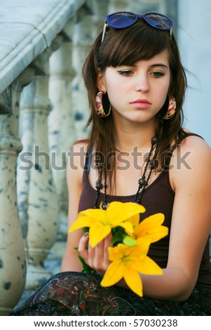 Sad young woman with lily.