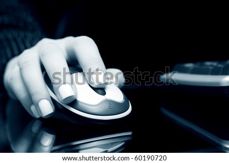 Female hand holding computer mouse.