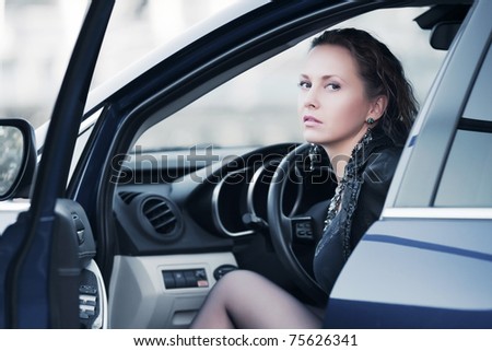 Young woman sitting in a sports car