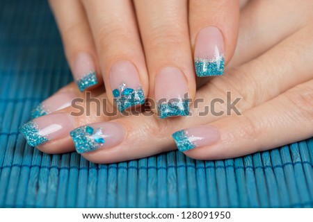 Manicure - Beauty Treatment Photo Of Nice Manicured Woman Fingernails. Very Interesting Nail Art With Glitter Blue And Silver Nail Polish.