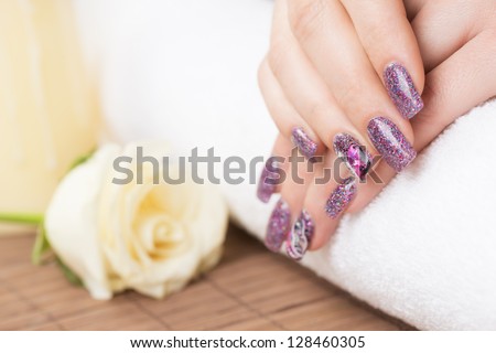 Manicure - Professionally manicured woman fingernails, with engagement ring. Studio shot.