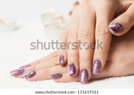 Manicure - Beautiful Manicured Woman\'S Nails With Glitter Purple Gel Nail Polish On Soft White Towel. Selective Focus.