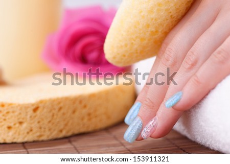 Manicure - Beautifully manicured woman\'s nails with blue nail polish and nail art on fourth finger having manicure treatment. Studio shot. Selective focus.