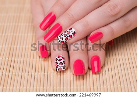Manicure - Beautifully manicured woman fingernails. Feminine nail art with interesting animal print nail art. Selective focus on finger with leopard print.