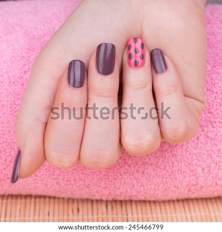 Manicure - Beauty treatment photo of nice manicured woman fingernails. Very nice feminine nail art with nice pink and purple nail polish.