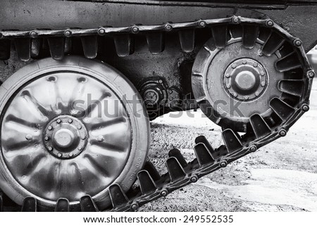 The wheels and caterpillars of a USSR military armored fighting vehicle. Black and white