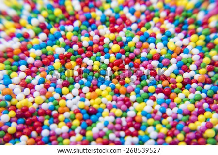 Macro of Sugar colorful balls powder background