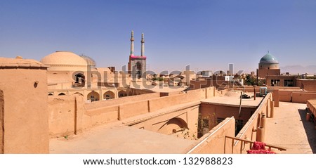 YAZD, IRAN - CIRCA AUGUST 2012: Jamah Mosque seen from the roofs of ancient buildings of Yazd circa August 2012. Yazd is one of the oldest cities in Iran.