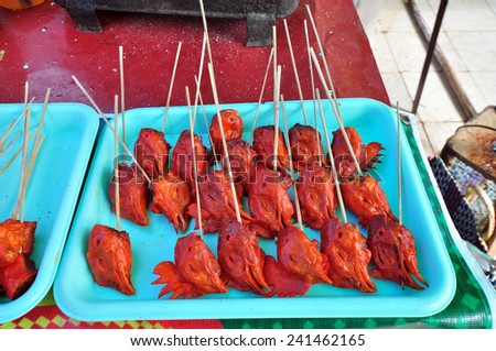 Grilled chicken head in a stall in Inle Lake. Grilled chicken pieces are a delicacy for the inhabitants of Myanmar (Burma).