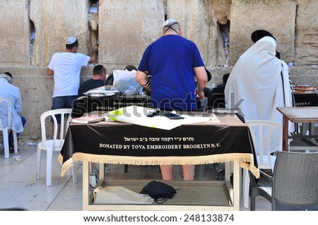 JERUSALEM, ISRAEL - circa August 2014: A hassidic Jew prays at the wailing wall in the Old City circa August 2014 in Jerusalem, Israel. The wall is is one of the most sacred sites in Judaism.